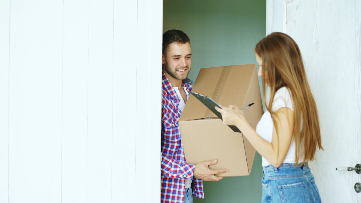 Courier handing a cardboard box to a customer who signs for it at a doorway